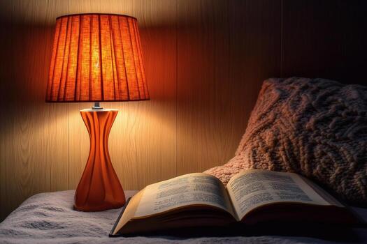Softly lit bedside table with a warm lamp and a book